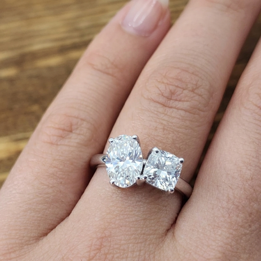 Diamond ring on a finger with a wooden background